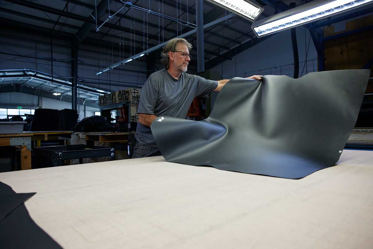 laying out leather for cutting patterns, Oberon Design workshop