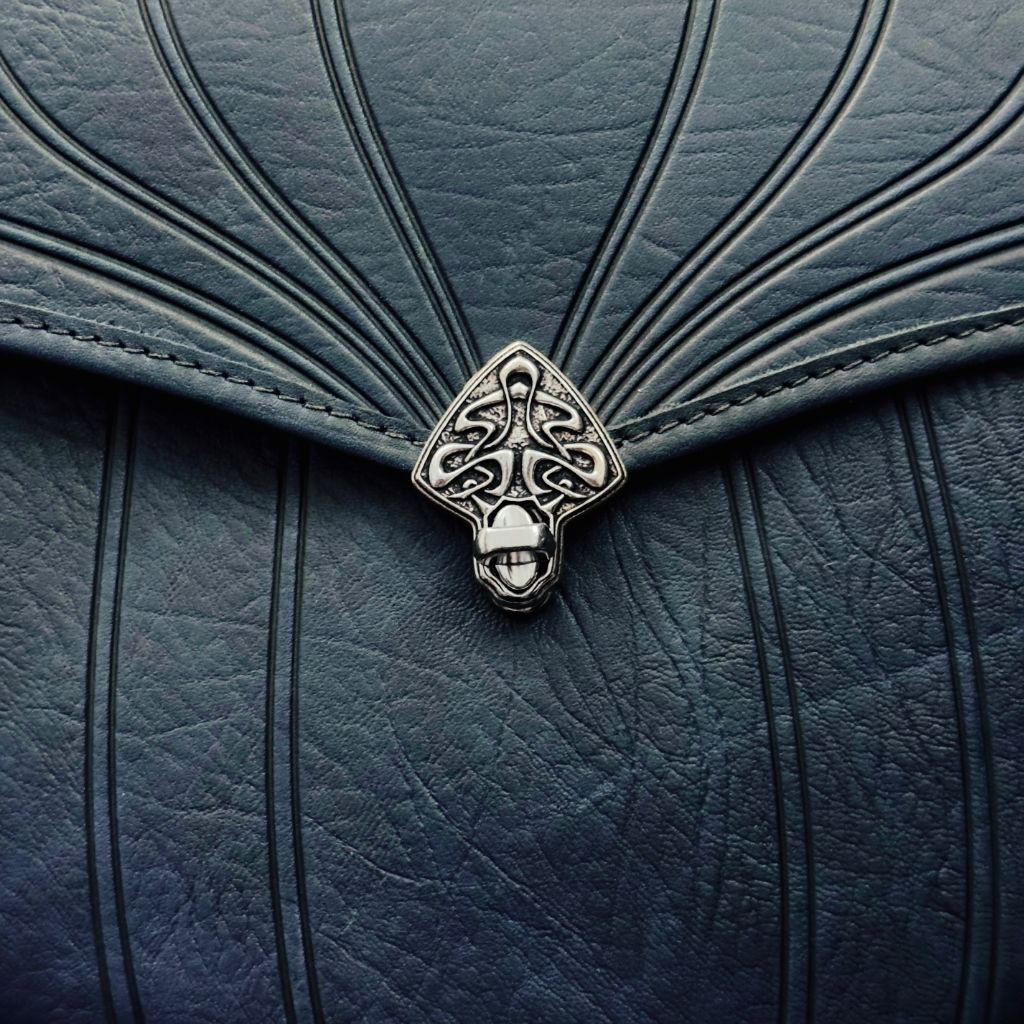 Leather Handbag, Olivia in Navy, Art nouveau swirl closure close up