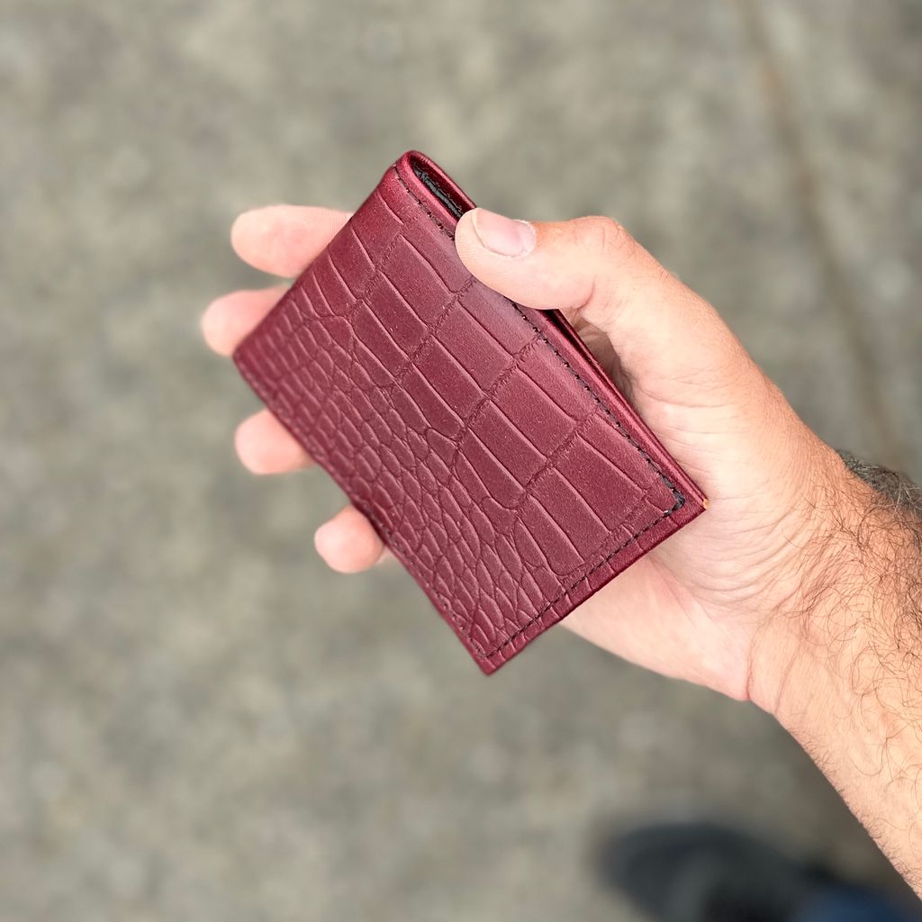 Oberon Design Bi-Fold Alligator Wallet in a Man's Hand
